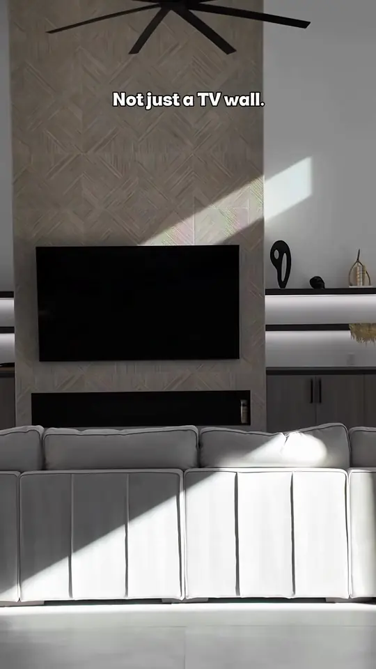 Custom media wall: floating shelves, LED lighting, base cabinets under the TV