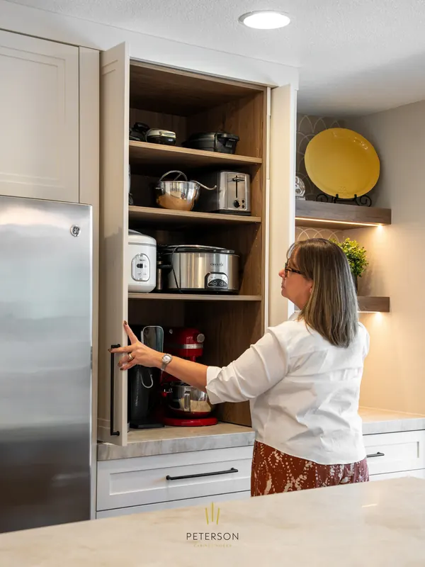 Karen opens the appliance garage in the Cotton White and Dark Rockford Hickory kitchen Karen opens the appliance garage in the Cotton White and Dark Rockford Hickory kitchen
