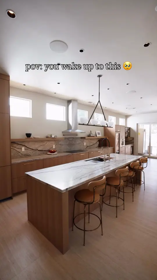 Warm wood kitchen: wine and coffee wall, panel-ready fridge, island, pantry pull-out, tall storage