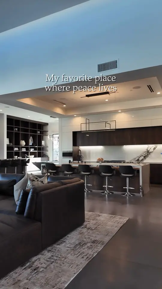 Modern great room into a dark-wood kitchen with a long island