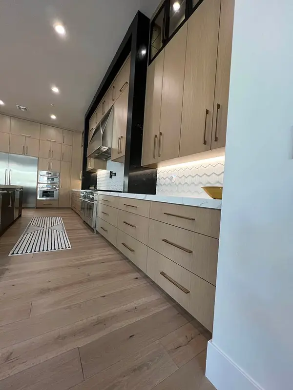 Hammer Matched grain slab rift white oak frameless custom cabinets