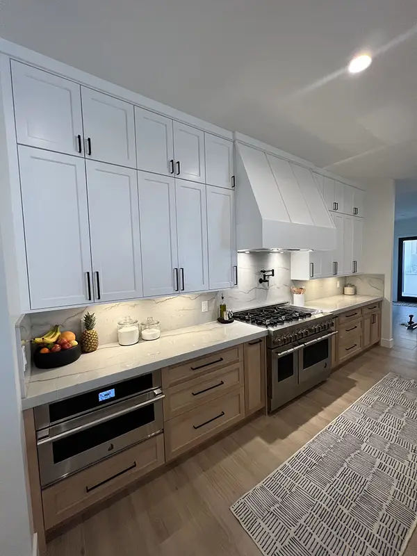 Peterson Cabinet Works Kitchen white shaker doors glass doors led lights rift white oak base cabinets custom hood 3