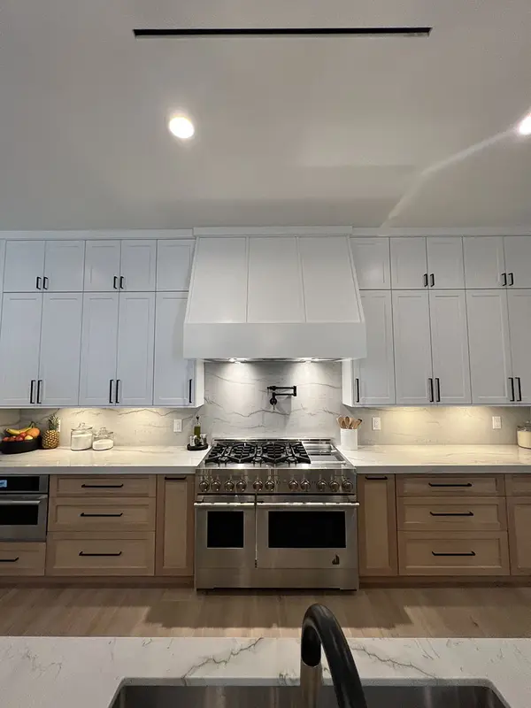 Peterson Cabinet Works Kitchen white shaker doors glass doors led lights rift white oak base cabinets custom hood