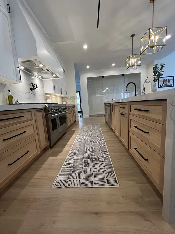Peterson Cabinet Works Kitchen white shaker doorsled lights rift white oak base cabinets custom hood