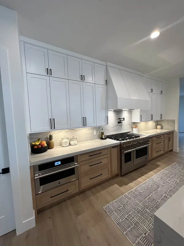 Milan white shaker doors glass doors led lights rift white oak base cabinets custom hood 2