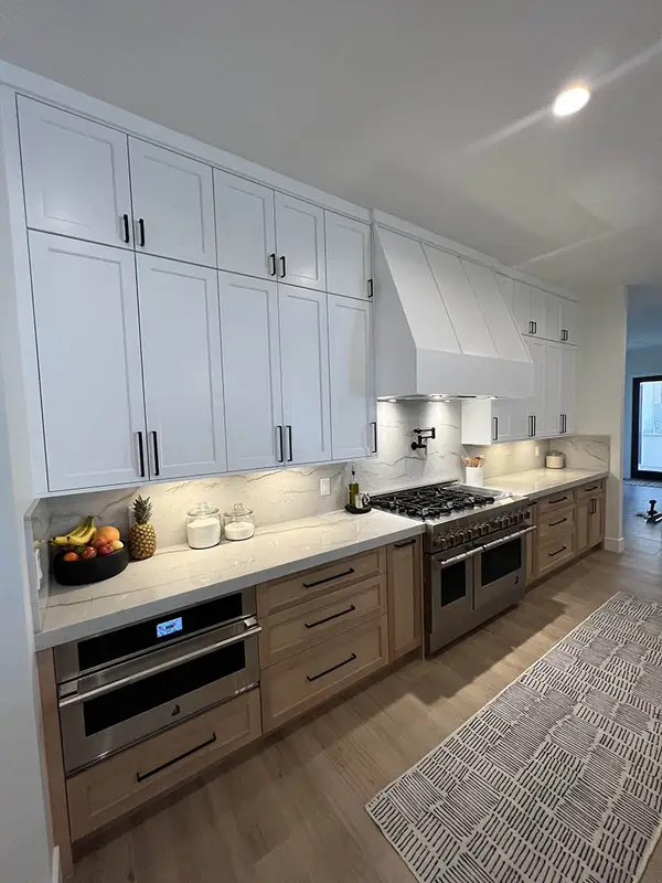 Milan white shaker doors glass doors led lights rift white oak base cabinets custom hood 3