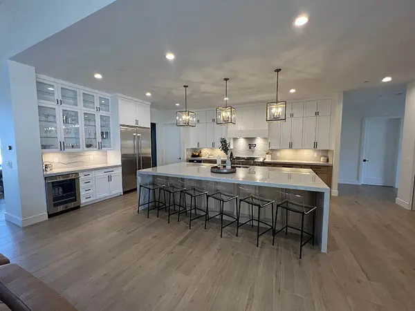 Milan white shaker doors glass doors led lights rift white oak base cabinets custom hood 4