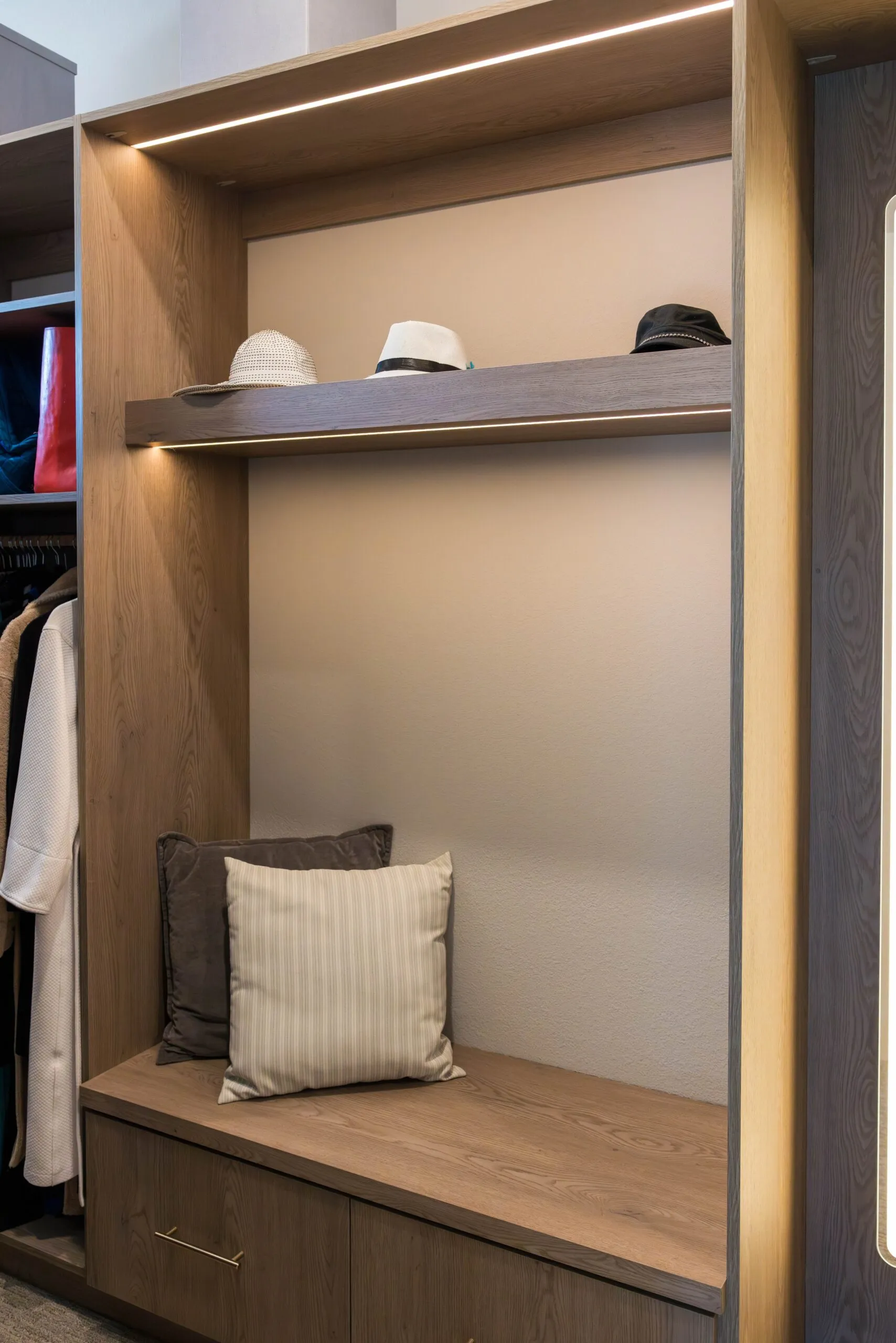 Built-in closet bench with LED lighting and a drawer below