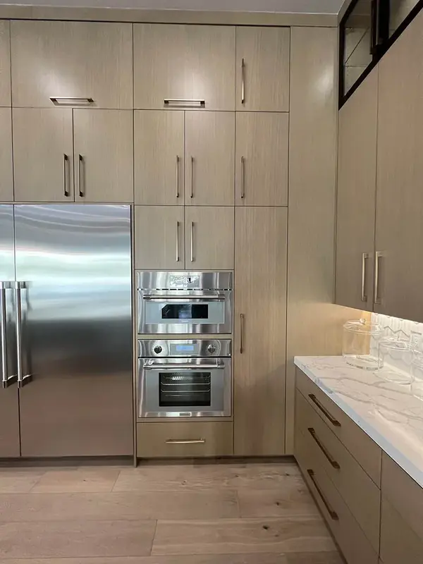 Hammer Matched grain slab rift white oak frameless custom cabinets applinances