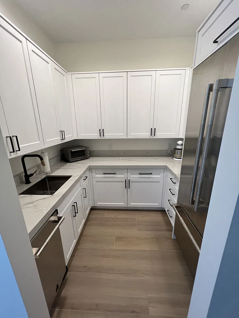 White Shaker custom pantry cabinets with pull-out storage