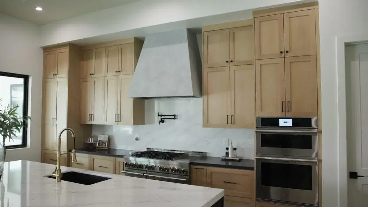 White oak custom kitchen cabinets with marble backsplash in a Las Vegas new build home