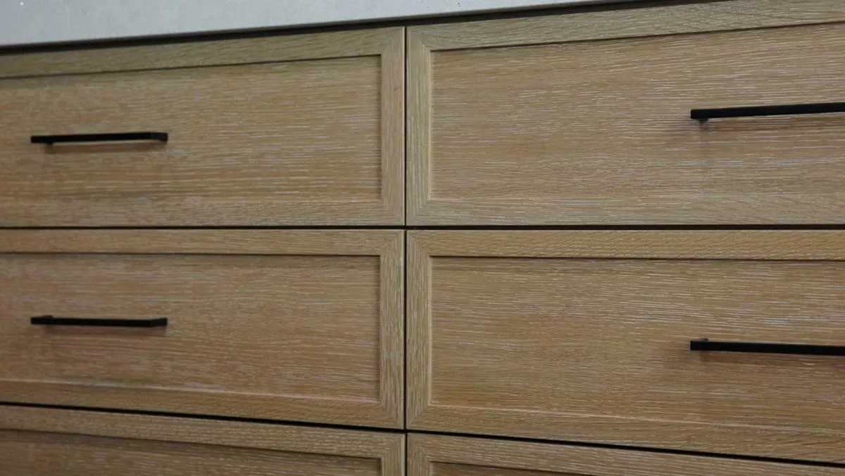 Perfectly aligned rift white oak cabinet doors and drawers with black hardware