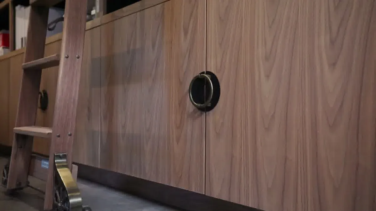 Walnut cabinet doors with recessed circular pulls built for a Las Vegas design showroom