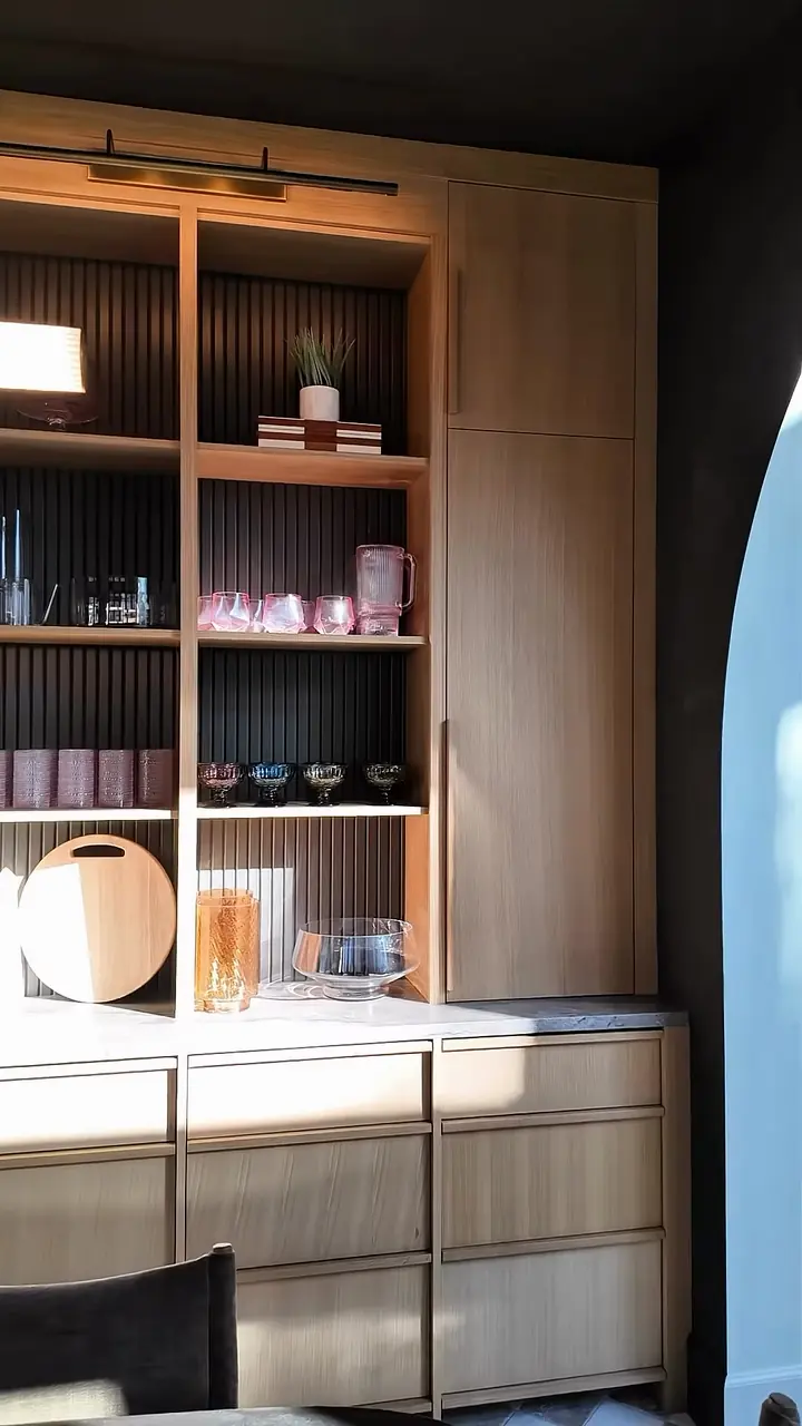 Light-wood dining hutch, fluted dark back, lit shelves