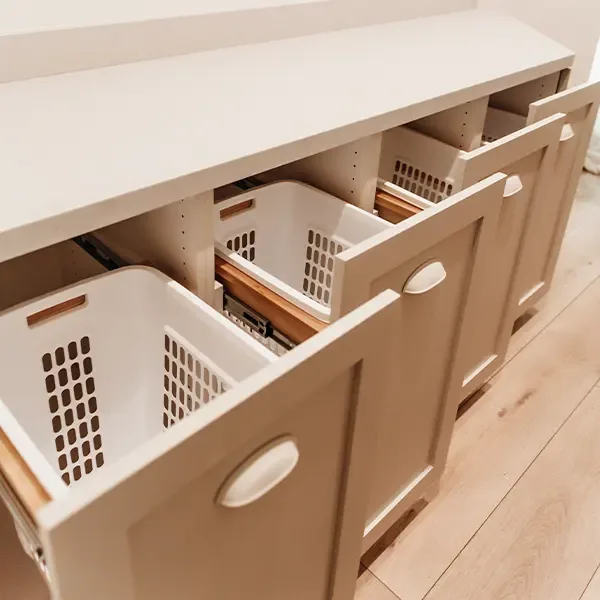 Pull-out laundry hamper drawers in custom cabinetry Pull-out laundry hamper drawers in custom cabinetry