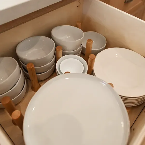 Wood drawer pegs holding stacked dishes in a custom drawer Wood drawer pegs holding stacked dishes in a custom drawer
